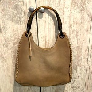 Gently used suede Gucci bag with classic wood handle. 12” x 7.5”